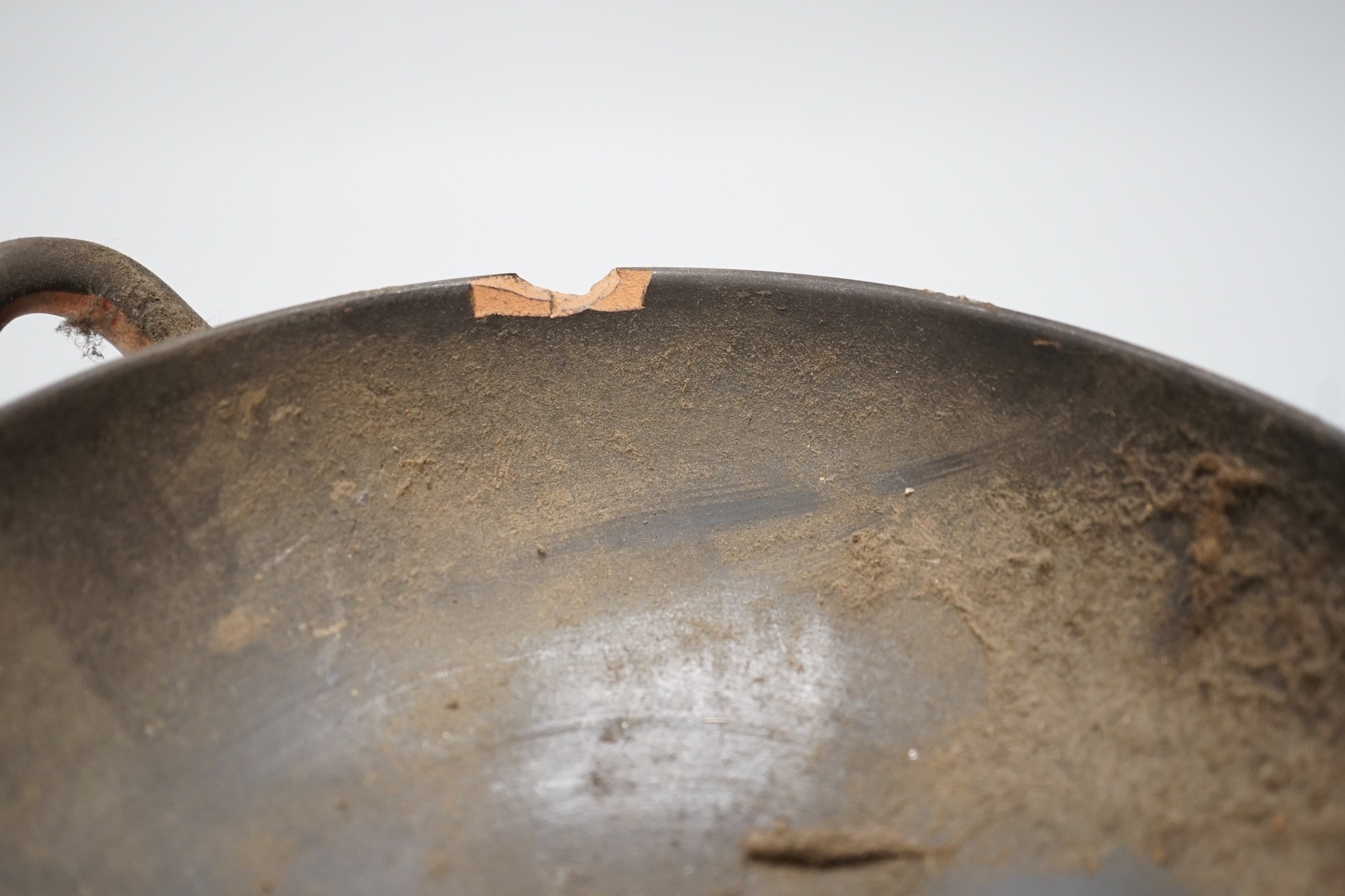 An Apulian black painted kylix, c. 4th century BCE., a Cypriot pottery flask, early Iron Age, two Roman terracotta oil lamps and another archaic vessel, tallest 14cm